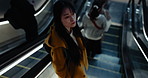 Timelapse, walking and woman on escalator for travel, commute and journey in Japan. Speed, motion blur and Japanese person at platform, location and electric stairs in building, subway or station 