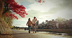 Love, holding hands and Japanese couple in city for bonding, relationship and relax together. Dating, romance and happy people talking, walking and travel in Japan for holiday, vacation and adventure