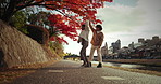 Love, dancing and Japanese couple in city for bonding, relationship and relax together. Dating, romance and happy man and woman dance, walking and travel in Japan for holiday, vacation and adventure