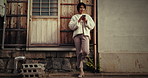 Japanese, street and woman with phone for social media, network and thinking with happiness. Person, typing and scroll online with blog, website and reading with a smile on smartphone outdoor