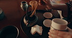 Herbs, teapot and Asian woman with tea with traditional leaves and indigenous recipe in home. Cup, ceremony and hands of person with herbal beverage for health, wellness and detox for drinking ritual