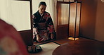Japanese, ceremony and traditional woman with tea, service and tray with matcha or ginseng. Asian, culture and calm master in kimono with respect for hospitality, heritage and movement on floor