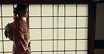 Walking, home and traditional Japanese woman in indigenous clothing, style and kimono for culture. Corridor, fashion and person in house for morning routine, wellness and ritual or hospitality 