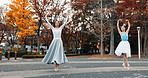 Nature, dancing and ballet women in a park practicing for concert, show or classical theater. Art, elegant and Japanese female ballerinas in rehearsal with music at outdoor garden or field in Autumn.