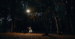 Woman, dancer and ballet in trees, nature and moving body for fantasy, night and freedom in performance. Person, girl and ballerina with dancing, steps and outdoor in dark woods, autumn and forest