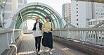 Japanese women, talking or walking on bridge for travel, bonding or leisure on weekend vacation in city. Friends, care or communication in tokyo town for holiday, wellness or relax together on social
