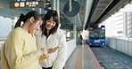 Friends, train station and smartphone for social media, laughing and happy with comments. Japan, public transport and streaming online with technology, funny and meme humour with communication