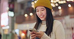 Smartphone, city and Japanese woman with smile, funny and connection with social media, laughing and joyful.  Typing, person or girl with a cellphone, internet and cheerful with humor and happy