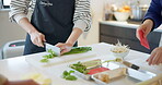 Japanese, cooking and hands of woman with vegetables in home chop with a knife on kitchen counter. Healthy, meal prep or people cutting food or spring onion for diet, nutrition or umami family dinner