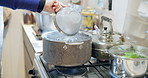 Hands, pot and stove with boiling water, cooking and ready with food, nutrition or diet with flame. Person, chef and kitchen employee in restaurant for meal prep, ingredients and container on fire