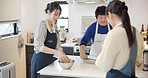 Cooking class, women and mixing to cook, chef and japanese food in kitchen, professional and skill. Restaurant, teaching and course for culinary skills, working together and aprons for cleanliness