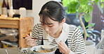 Japanese woman in restaurant, eating noodles and food for lunch or dinner. Ramen, bowl and a young hungry person, customer or girl with chopsticks to enjoy healthy meal, soup or traditional cuisine