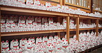 Tokyo, shrine and Japanese cat doll decoration, art and lucky fortune as symbol for success. Maneki neko, animal and beckoning kitten statues for traditional shinto culture, religion and figurine