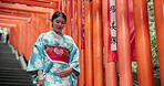 Woman, Japan and walking in kimono or traditional visit to Fushimi Inari, shrine in Kyoto. Female person, temple clothes and path to worship building for spiritual outdoor journey, zen or heritage