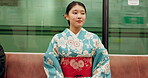 Japan woman, travel and train in kimono, happy and metro transport on vacation in positive attitude. Person, smile and traditional clothes in fast vehicle on trip and commute in town for adventure