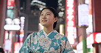 Woman, happy and walking in city with kimono, travel and leisure in heritage celebration in positive attitude. Person, smile or traditional clothes by urban town buildings or journey in tokyo culture