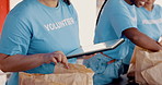 People volunteering, tablet and food donation in community service, poverty support and NGO checklist. Nonprofit, hands or group packaging groceries, planning package or helping for charity project