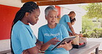 Teamwork, volunteer and women on tablet for charity discussion, meeting and planning. Volunteering, collaboration and people in digital tech talking for donation, ngo business and community service