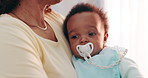 Cute, bonding and mother holding baby with pacifier for calming with love and care at family home. Trust, embracing and closeup of mom carrying sweet boy infant, child or newborn in modern house.