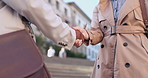 Handshake, collaboration and closeup of business people in the city with corporate agreement. Greeting, onboarding and zoom of professional colleagues shaking hands for welcome in urban town.