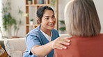 Happy woman, nurse and consulting in elderly care, support or trust for healthcare, advice or comfort at old age home. Female person, doctor or caregiver touching or talking to patient in living room