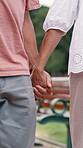 Couple, holding hands and walking in park or closeup for together support, connection or bonding. People, marriage and fingers embrace for nature explore on weekend for relax, holiday or commitment