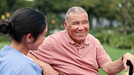 Senior man, caregiver and conversation in outdoors, rehabilitation and humor in consultation. Park bench, nurse and elderly person with disability, walking stick and cane for balance or support