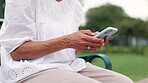 Hands, phone and playing game in outdoors, text message and scrolling on website or blog. Park bench, person and searching on internet or social media, online and app for conversation on technology