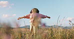 Woman, freedom and dancing in field of flowers, countryside and peace in sustainable environment. Female person, holiday and adventure in nature or outdoors, calm and zen or wellness on vacation