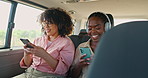 Phone, music and friends in car for road trip, travel or journey together on summer vacation. Smile, social media and headphones with young women on mobile app in vehicle for holiday transportation