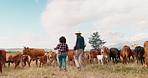 Agriculture, woman and man with cow field, conversation on sustainability or cattle farming in African countryside. Nature, animals and farmer couple with small business discussion in food production