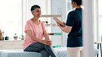 Mature, results or happy woman in consultation for physiotherapy with checklist, news or clipboard. Rehabilitation, smile or patient talking for trauma evaluation with a physiotherapist writing notes