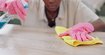 Cleaning, table and gloves of woman in home with cloth  for hygiene, disinfection and dust on furniture. Housekeeping, spring clean and closeup of hands with detergents, spray bottle and products