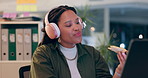 Woman, headphones and laptop in night at startup, eating and pizza with dancing late in dark office. Girl, person or employee with computer, music or fast food at social media manager job with dinner