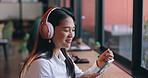 Phone, music and asian woman singing in coffee shop to relax by window for streaming radio playlist. Mobile, smile and headphones with happy young person listening to audio in cafe or restaurant