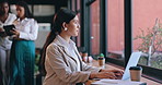 Coffee shop, thinking and woman with a laptop, typing and connection with internet, creativity and copywriter. Cafe, person or girl with computer, ideas or opportunity with thoughts or writing a blog