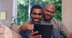 Smile, tablet and gay couple on sofa, talking and communication on social media at home. Technology, lgbtq and happy African men in living room on internet, app or online shopping together on website