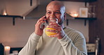 Man, phone call and glass of juice in home, night or smile in conversation, communication or funny chat. Person, smartphone and happy with healthy drink, listening and mobile connection in apartment