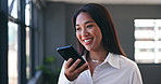 Cellphone, voice recognition and business woman in office by window for mobile communication. Smile, technology and professional Asian female person record message or on call with phone in workplace
