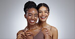 Women, face and skincare with happiness in studio with facial treatment, diversity or glowing skin. Friends, model and portrait with mock up for cosmetics, dermatology and support on gray background