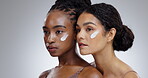 Women, face cream and skincare with diversity in studio with facial treatment, happiness or glowing skin. Friends, model and girl for cosmetics, dermatology or body care on mockup or gray background
