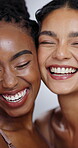 Women, face and skincare with laughing in studio with facial treatment, diversity or glowing skin. Friends, model and portrait with mock up for cosmetics, dermatology and support on white background