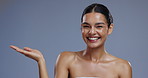 Woman, hand and mockup space, beauty advertising and face with dermatology and presentation for skincare in studio. Annoucement, launch or news with cosmetic care, excited model on grey background