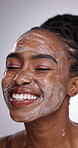 Beauty, skincare and black woman with face wash in a studio for natural and clean routine. Smile, health and young African female person with facial dermatology cleanser treatment by gray background.