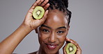 Beauty, skincare and face of black woman with kiwi on white background for wellness, cosmetics and makeup. Dermatology, spa and portrait of happy person for natural, organic or healthy skin in studio