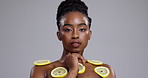 Black woman, lemon and skincare for vitamin C, beauty or detox on a gray studio background. Portrait of African female person, face or model in relax with natural organic citrus fruit on mockup space