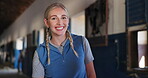 Smile, equestrian and woman in stable on ranch for hobby as trainer or professional jockey. Portrait, western or rural with happy young blonde person in barn or stall as rural cowgirl and rider