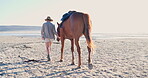 Woman, freedom and horse relaxing on beach, nature and peaceful vacation or holiday by ocean. Female person, animal and back view while walking on shore, calming and sea adventure on coast and travel