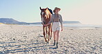 Woman, adventure and horse relaxing on beach, nature and peaceful vacation or holiday by ocean. Happy female person, animal and smile while walking on shore, calming and freedom on coast and travel