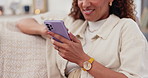 Hands, phone and social media with woman on sofa in living room of home closeup for communication. Contact, smile and internet with happy person typing text message in apartment for networking